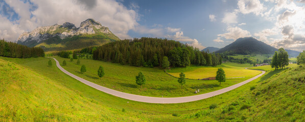 Meadow with road and bench during sunset in Berchtesgaden National Park
