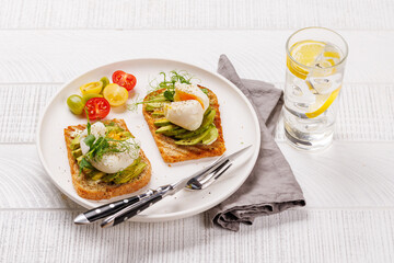 Delicious avocado toasts topped with perfectly cooked poached eggs