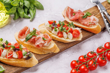 Tasty antipasto toasts featuring classic caprese with mozzarella and tomatoes, and savory...