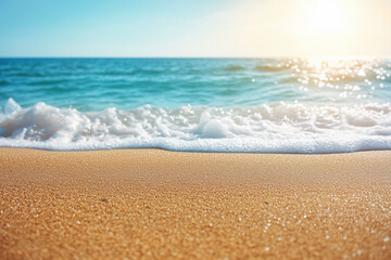Waves gently lap against a sandy beach under a bright sun in a coastal setting