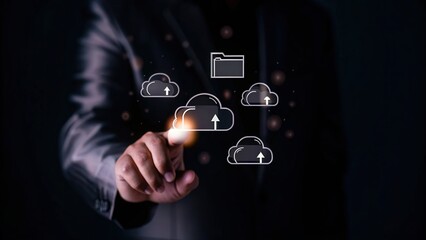 Businessman interacting with cloud storage icons on a digital screen.