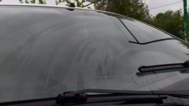 A car with a windshield wiper blade on the windshield