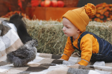 Baby crawling next to a chick