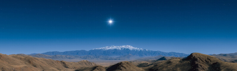 Celestial Heights: A breathtaking landscape showcasing a majestic snow-capped mountain range under a brilliant star in a clear, cerulean sky. A harmonious blend of earth and sky.