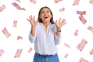 Cheerful young Asian woman rejoicing success with money banknotes flying in the air isolated on...