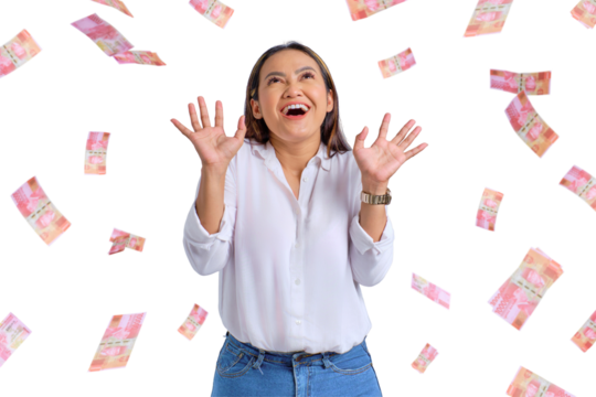 Cheerful young Asian woman rejoicing success with money banknotes flying in the air isolated on transparent background