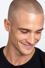 Fototapeta premium Realistic photo of attractive man around 25 years old with shaved hair, after scalp looking slightly downward.