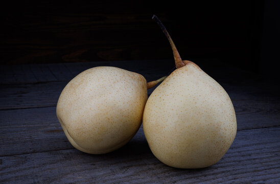 Two ripe juicy pears on a wooden background. Snow pear.
