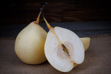 Whole and half a ripe pear. Snow pear.