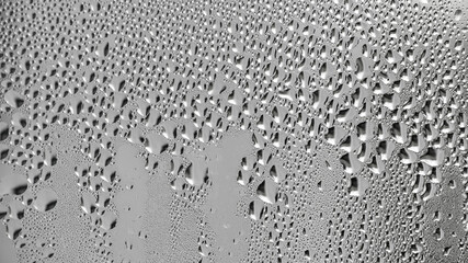 background, unusual, abstract. drops of morning dew, condensation on the glass. wet glass. water drops close-up. beautiful background for text. Spray cool condensate water on the glas