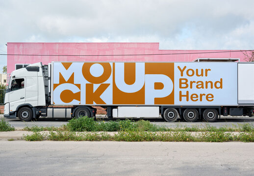 A large white truck is stationary on a city road. PSD template mockup