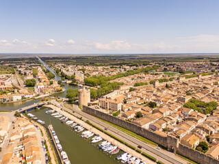 Aigues-Mortes, Camargue, France, medieval city with its surrounding walls, the Constance Tower, and typical southern french houses, canals for boats