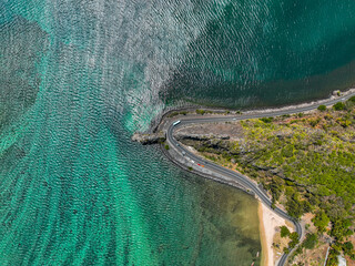 Top down aerial view of the emerald Indian Ocean meeting cliffs and coastal curves at the famous Maconde Viewpoint, Mauritius