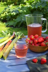 Fresh strawberry and rhubarb compote on a table in the garden.