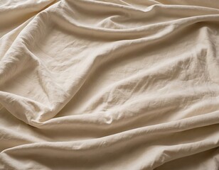 Fototapeta premium Close-up of soft, wrinkled beige fabric creating a calm and cozy aesthetic.