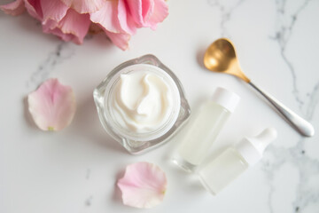 Elegant Beauty Product Arrangement with Floral Accents and Tools