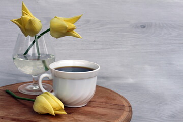 A cup of coffee will lift your spirits in a free moment, and tulips will make you smile