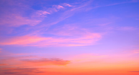 Evening sky background with colorful orange and pink sunlight clouds on beautiful romantic blue sunset sky, Summer fantastic sunrise sky backdrop