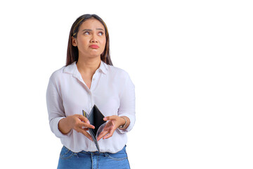 Unhappy young Asian woman holding empty wallet and looking away at copy space isolated on transparent background