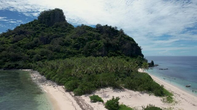 Tropical island with palm trees beach, help me sign, and boat anchored- aerial rotating