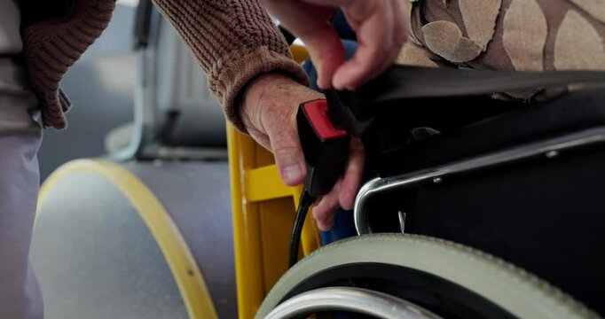 Wheelchair, belt and bus with hands of people or safety, handicap policy and helping. Security, public transportation and closeup of person with a disability and strap for journey and metro travel