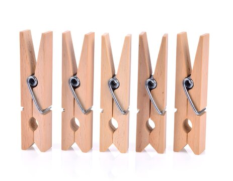 Wooden clothes pegs on white background