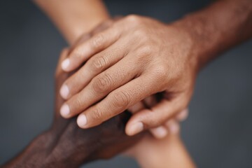 Diverse Hands Together in Unity and Support on Dark Background