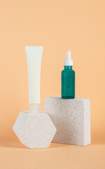 Plastic white tube for cream or lotion. Skin care or sunscreen cosmetic with stylish props on cream background.