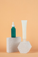 Plastic white tube for cream or lotion. Skin care or sunscreen cosmetic with stylish props on cream background.