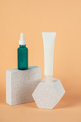 Plastic white tube for cream or lotion. Skin care or sunscreen cosmetic with stylish props on cream background.