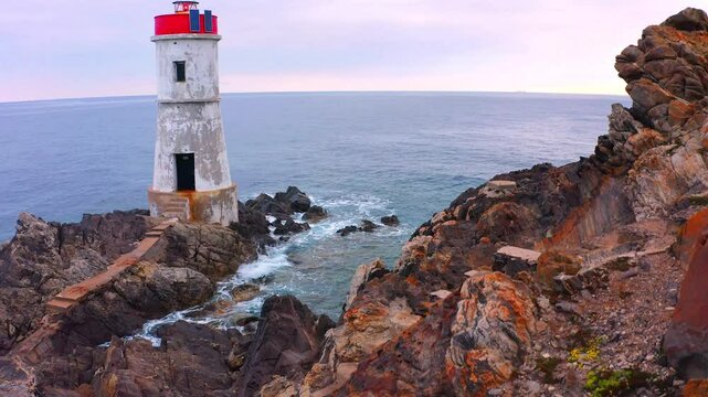 4k drone flight up footage (Ultra High Definition) of di Capo Ferro Lighthose. Rocky summer scene of Sardinia island, Italy, Europe. Beautiful Mediterranean seascape. Traveling concept background.