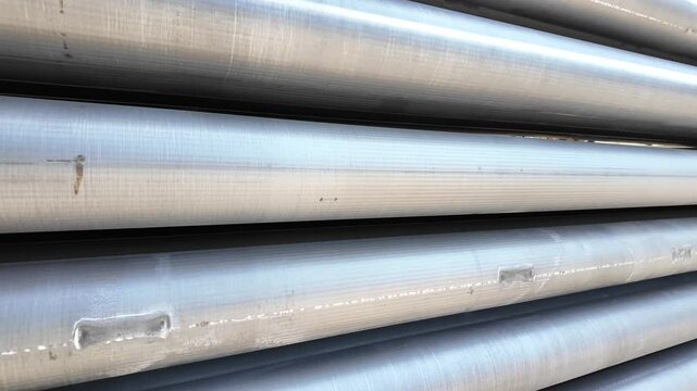 Aluminium round bars in outdoor storage. Pile of aluminum billets logs 
