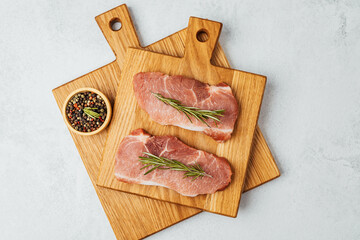 Freshly sliced meat with herbs on wooden cutting boards in a bright kitchen