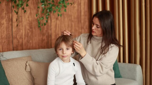 Mother, checking her sons hair for lice, precautions child hair