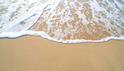 Close-up soft wave of the sea on the sandy beach