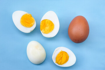 several halved boiled eggs on blue background
