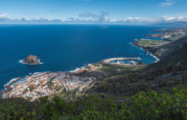 Aerial view of old town Garachico from Mirador de Garachico view point. Colorful houses and harbor. Ocean shore with lava rock pools. Popular tourist destination, Tenerife Canary Islands.