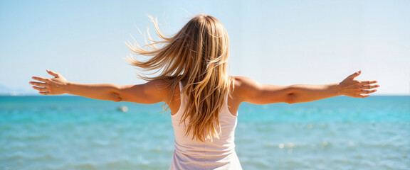 Naklejka premium Woman embracing freedom by the ocean under a clear sky 