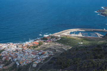 Aerial view of old town Garachico from Mirador de Garachico view point. Colorful houses and harbor. Ocean shore with lava rock pools. Popular tourist destination, Tenerife Canary Islands.