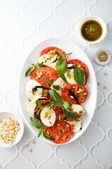 Traditional Caprese salad with pesto sauce