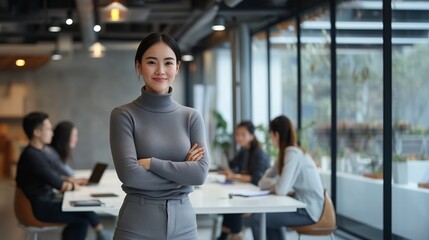 Fototapeta premium Professional woman stands confidently in modern office during a team meeting