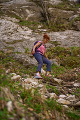 Woman descending rocky mountain path