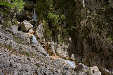 Waterfall cascading through rocky ravine