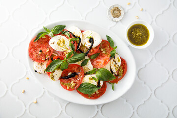 Traditional Caprese salad with pesto sauce