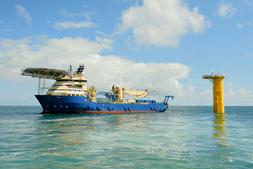 DP3 Cable Laying Vessel Positioned Next to Offshore Wind Turbine Foundation With ROV Deployed