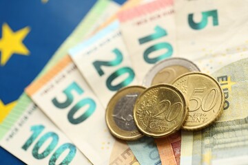 European union money currency Euro different paper notes and coins on flag