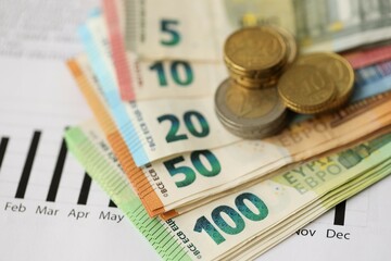 European union Euro money bills and coins with european electricity utility bill on table