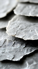 Stacked light gray stone slabs, close-up view of textures