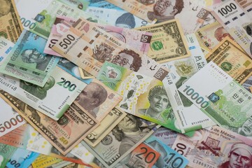 Big amount of money bills of different currencies and countries. Assortment background of international cash in big pile close up