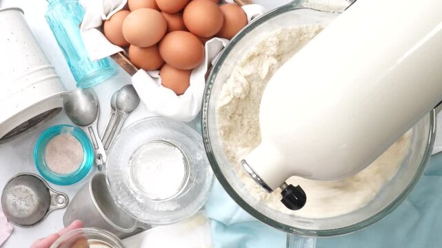 Baking a triple layer light blue cake with buttercream icing.  Decorating a vanilla cake for spring time.  Icing a cake and using coconut and candy eggs to make it look like a robin egg.